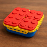 Colorful container with red, yellow, and blue design on a wooden surface