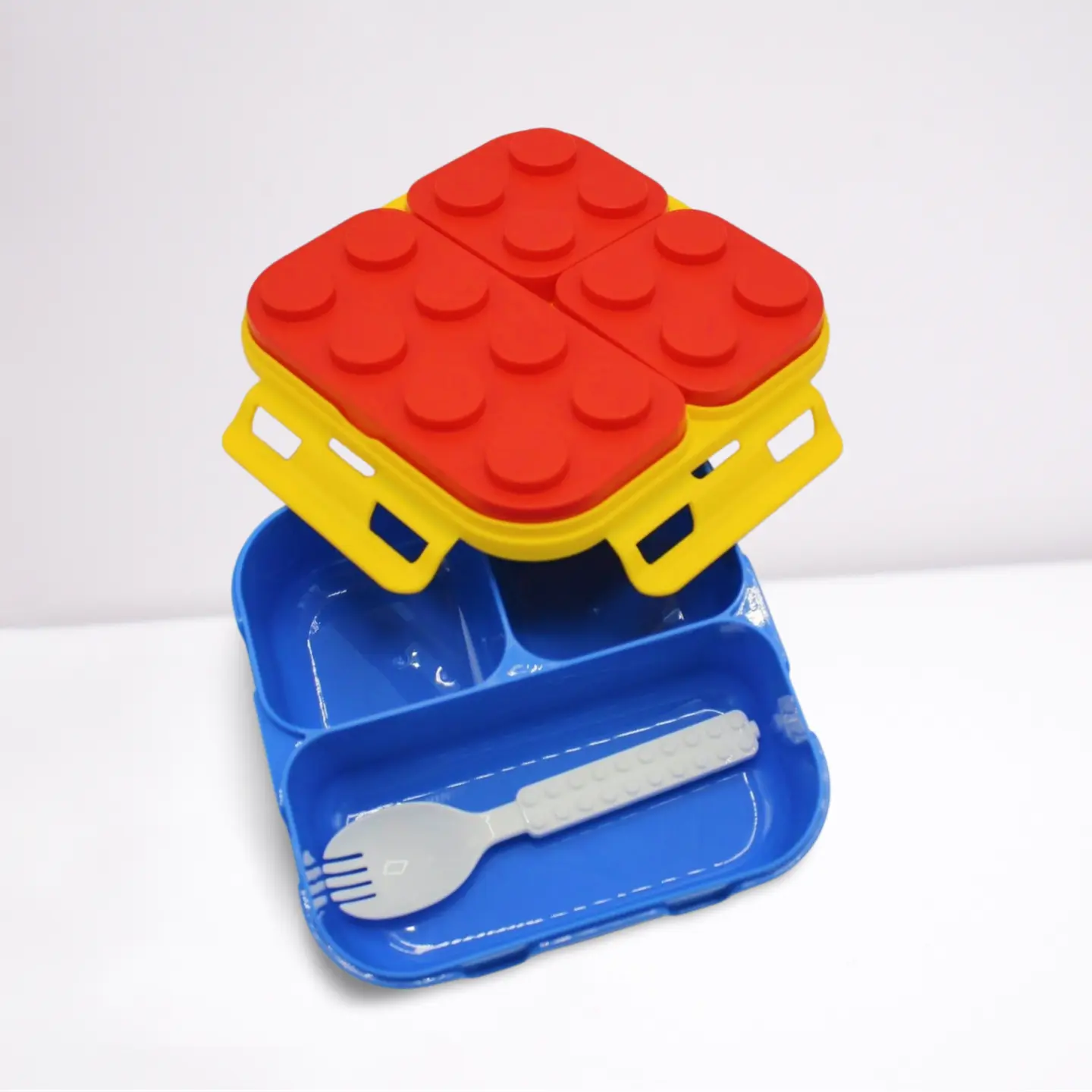 Colorful children's plate set with red and yellow block design on a white background